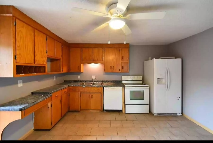 kitchen with wood cabinets, white appliances, and a ceiling fan